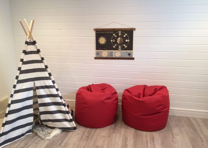 Basement playroom with shiplap walls.