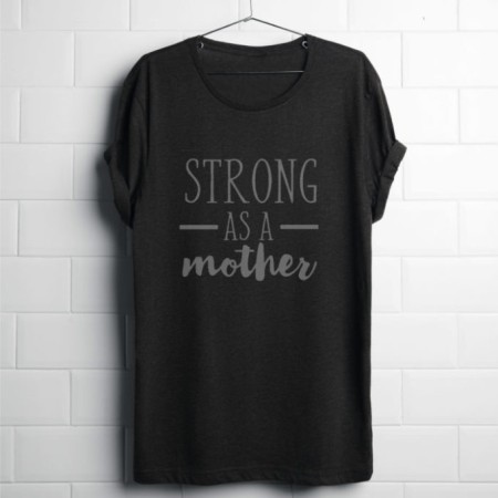 strong as a mother shirt hanging against a brick wall.