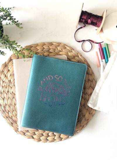 diy composition book cover made with leather and an iron on vinyl design