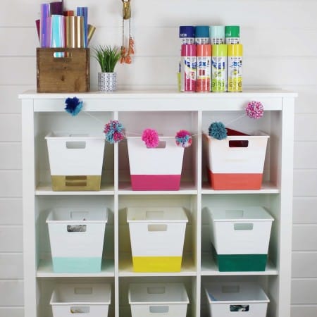 Craft room organization with storage bins spray painted in rainbow colors using spray paint.