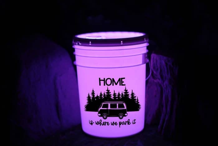 Make your own camping bucket light to welcome guests to your campsite.  Full instructions and free camping svg file included!