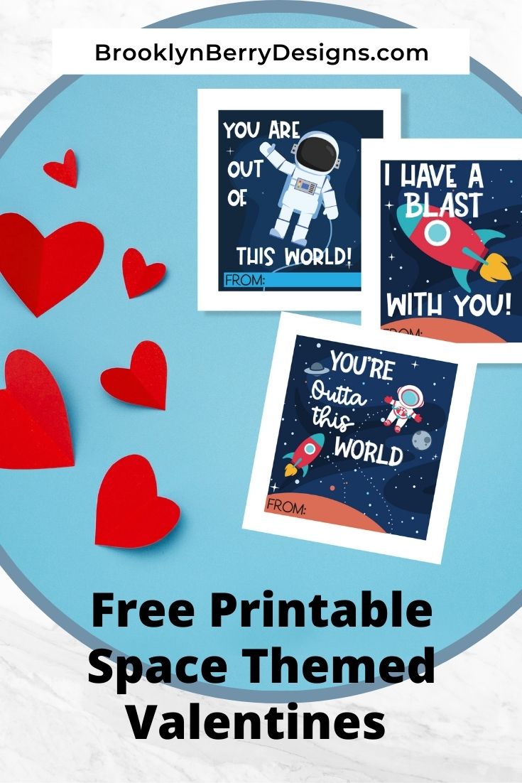 cut out paper hearts and paper with space themed valentines cards.