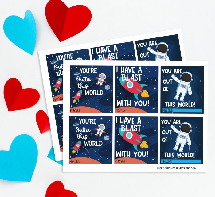 cut out paper hearts and paper with space themed valentines cards.