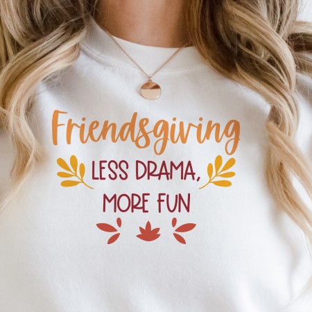 Women wearing a sweatshirt with the phrase "friendsgiving - less drama more fun"