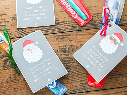 gift tags on tooth brushes with a gift card of santa.