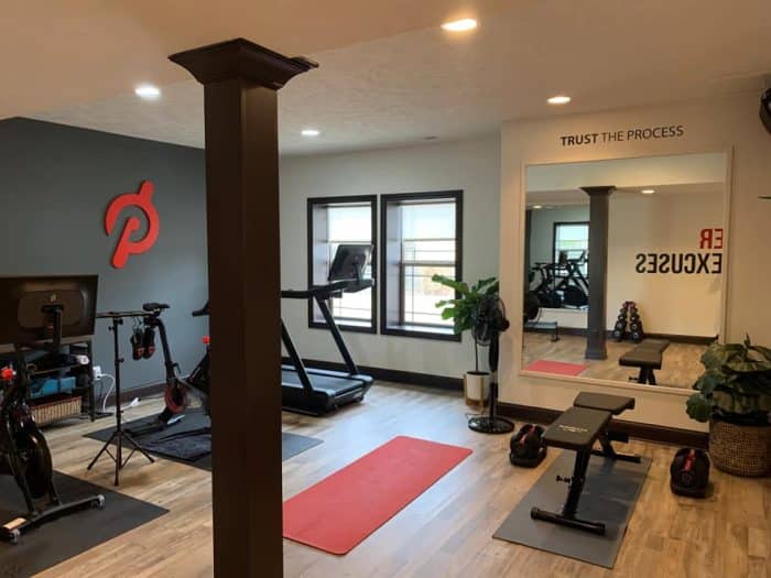 a full home gym with a peloton bike and peloton tread