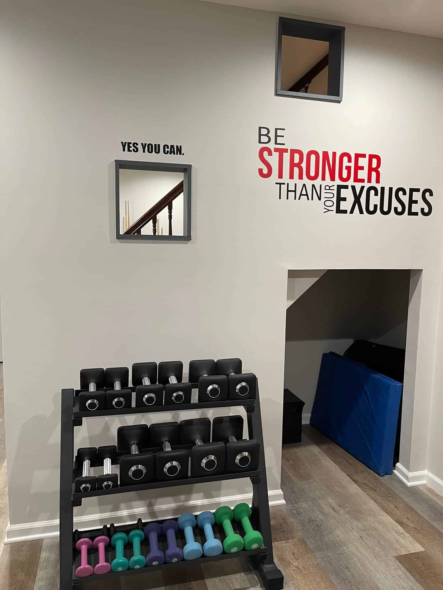 home gym weight storage and motivational wall decor
