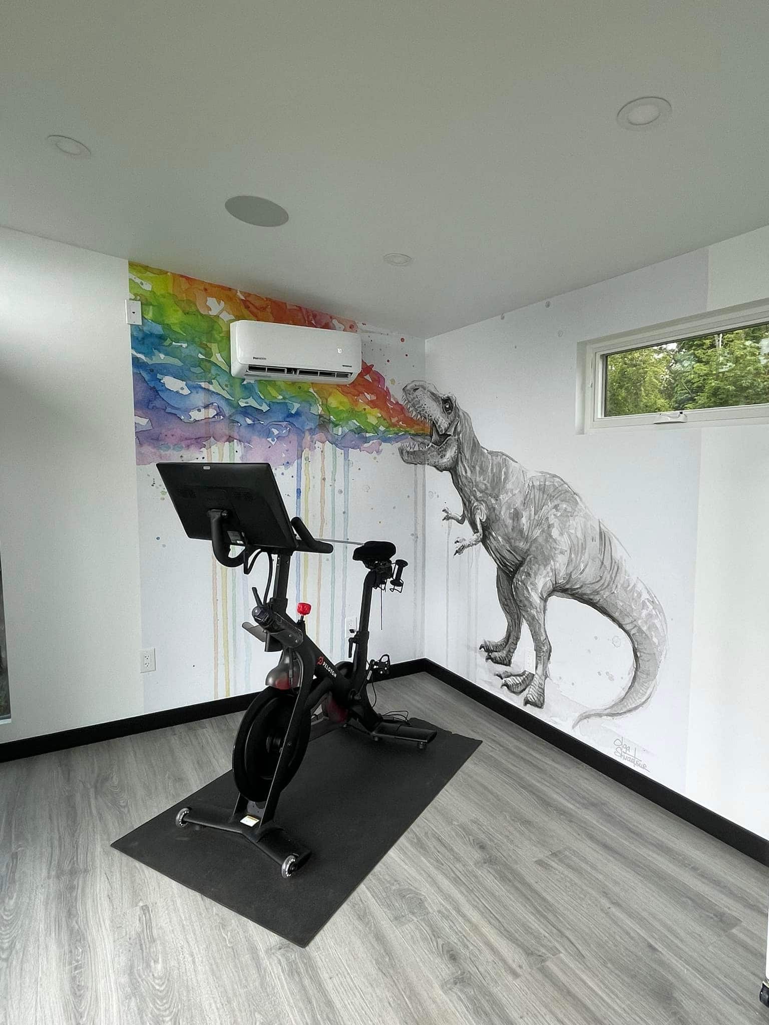 peloton room with dinosaur on wall
