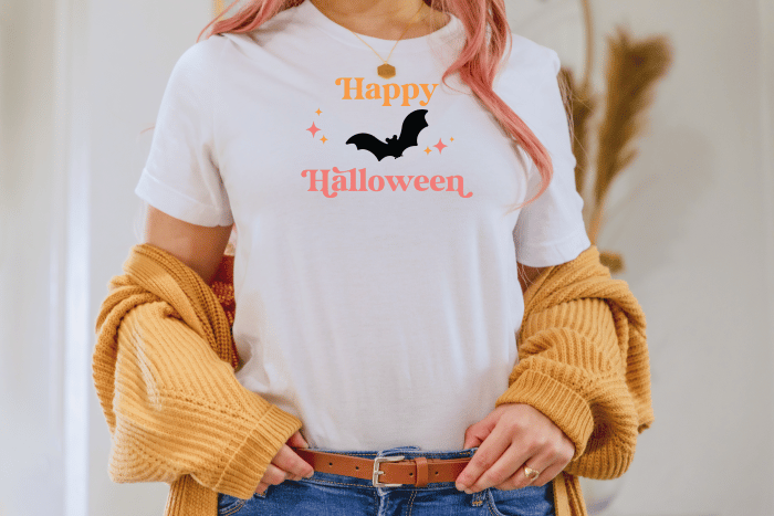 white shirt with design of bat and happy halloween and midcentury style stars.