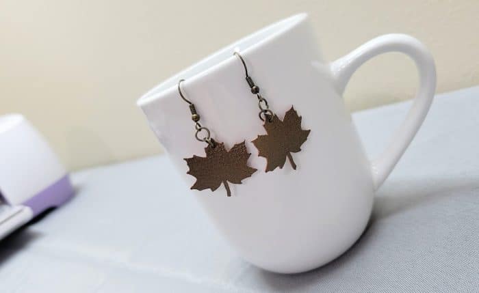 leather earrings in the shape of a maple leaf