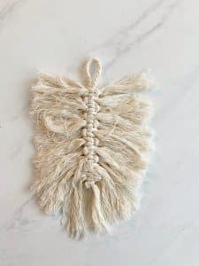 simple macrame cords showing the process of how to make a macrame feather