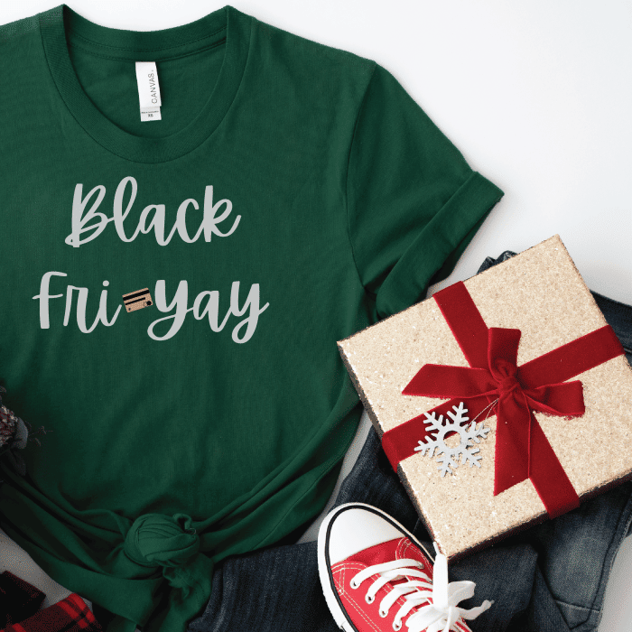 a green tshirt with jeans, red converse shoes, and a gold present wrapped with a red bow and snowflake ornament.