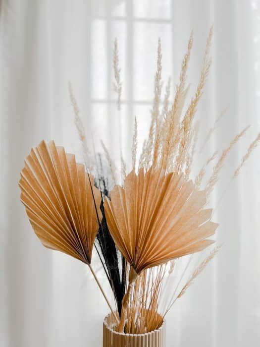floral arrangement with dried grasses and diy paper palm fronds