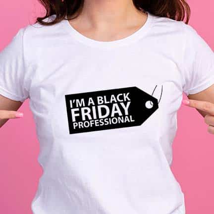 a woman in a white tshirt on a pink background pointing to a design on a price tag and the text I'm A Black Friday Professional.