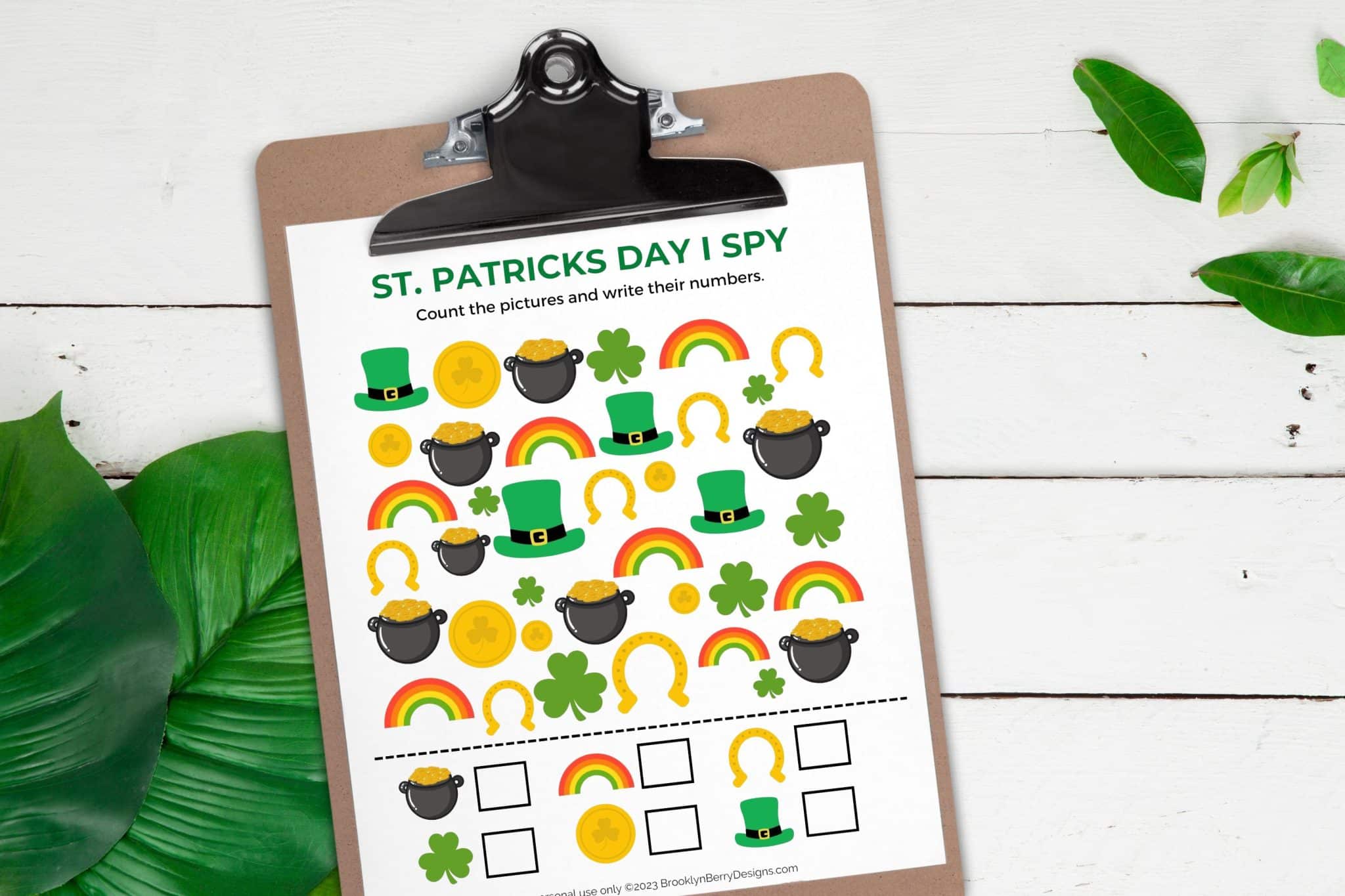 Wood background with a clipboard holding a st patricks day themed i spy game