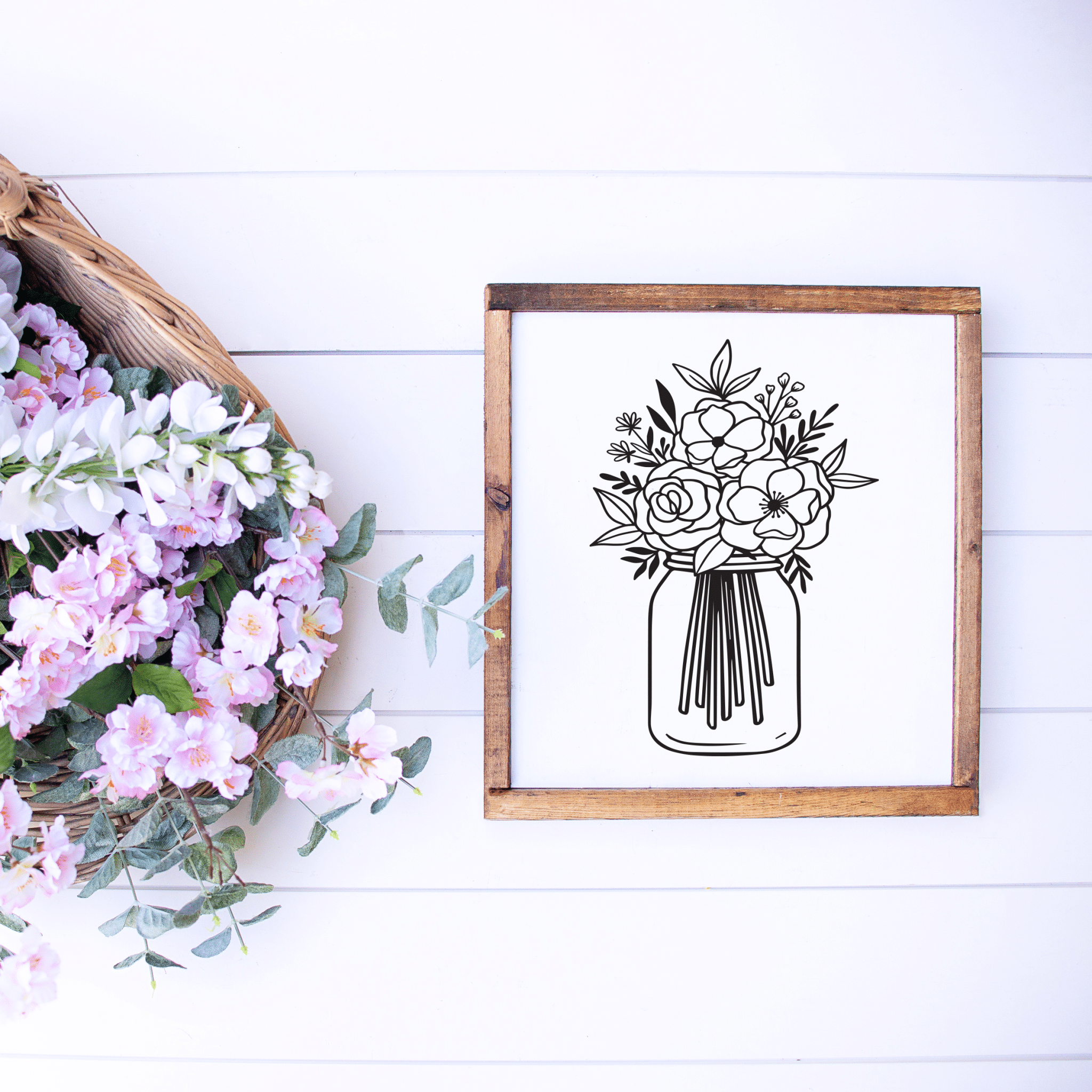 wood farmhouse sign with an image of wild flowers in a mason jar