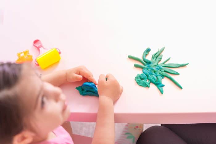 little girl playing with playdough