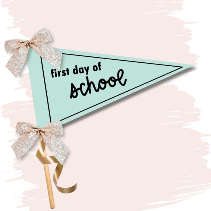 a printed first day of school pennant banner on a stick with ribbons and bows