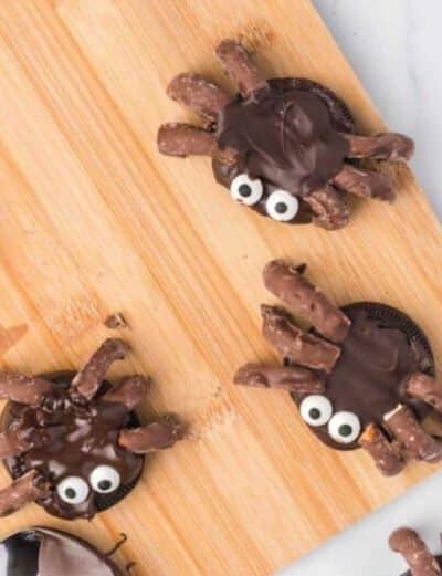 Cute spider cookies for halloween made from oreos dipped in chocolate and pretzels.